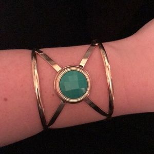 Gold cuff bracelet with a turquoise accent